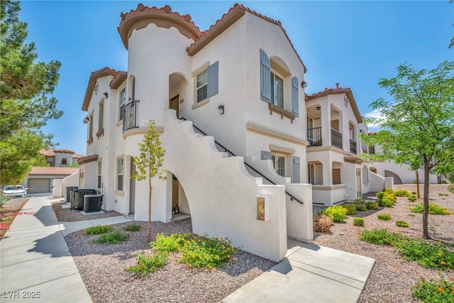 50 Aura De Blanco St Unit 2104, Henderson, NV 89074 - view of home's exterior featuring stucco siding, a tile roof, a balcony, and central AC