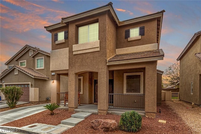 2199 Timescape Ct, Las Vegas, NV 89123 - view of front of home featuring a porch, stucco siding, concrete driveway, and a garage