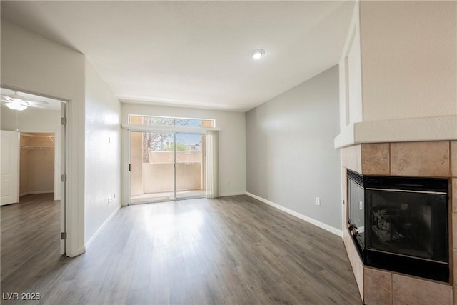 7400 W Flamingo Rd Unit 1082, Las Vegas, NV 89147 - unfurnished living room with a tile fireplace and wood finished floors