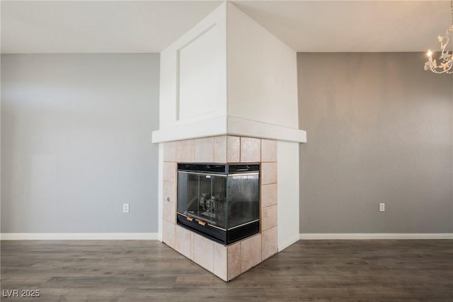 7400 W Flamingo Rd Unit 1082, Las Vegas, NV 89147 - detailed view of wood finished floors, a chandelier, and a tile fireplace