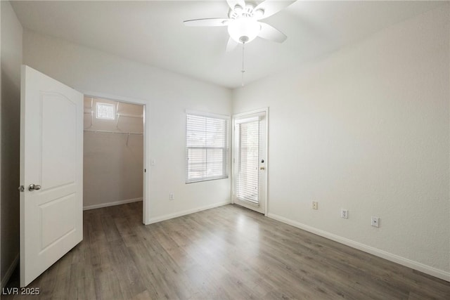 7400 W Flamingo Rd Unit 1082, Las Vegas, NV 89147 - unfurnished bedroom with wood finished floors, a walk in closet, a closet, and a ceiling fan