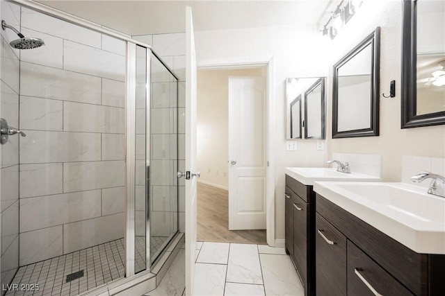 7400 W Flamingo Rd Unit 1082, Las Vegas, NV 89147 - bathroom featuring a shower stall, vanity, and marble look tiles