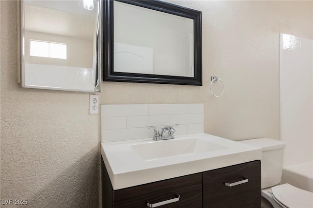7400 W Flamingo Rd Unit 1082, Las Vegas, NV 89147 - bathroom featuring vanity, tasteful backsplash, and a textured wall