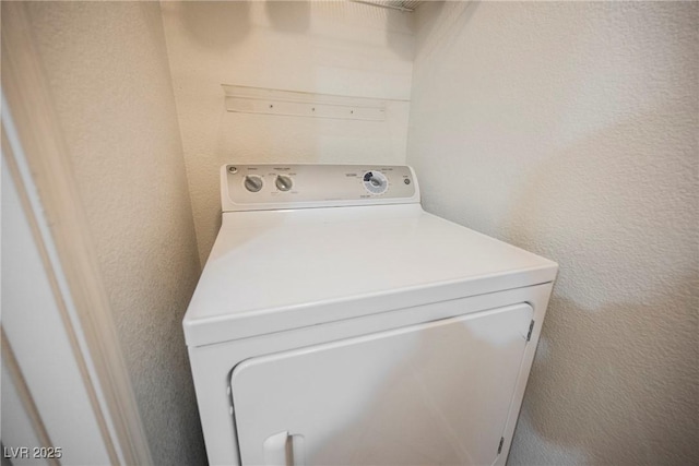7400 W Flamingo Rd Unit 1082, Las Vegas, NV 89147 - washroom with washer / dryer and a textured wall