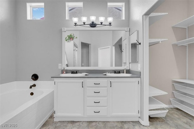 509 Regal Robin Way N, Las Vegas, NV 89084 - bathroom featuring a bath, double vanity, and a chandelier