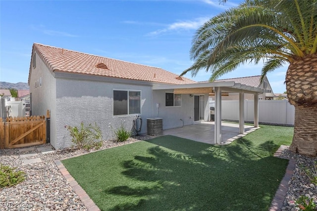509 Regal Robin Way N, Las Vegas, NV 89084 - rear view of house featuring a tiled roof, stucco siding, a patio, and a gate