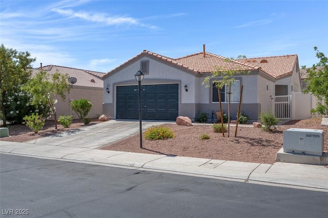 509 Regal Robin Way N, Las Vegas, NV 89084 - mediterranean / spanish-style home featuring stucco siding, a tile roof, concrete driveway, and an attached garage