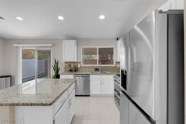 509 Regal Robin Way N, Las Vegas, NV 89084 - kitchen with appliances with stainless steel finishes, a sink, white cabinetry, light stone counters, and recessed lighting