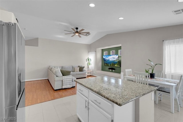 509 Regal Robin Way N, Las Vegas, NV 89084 - kitchen with stainless steel fridge with ice dispenser, lofted ceiling, ceiling fan, white cabinets, and a kitchen island