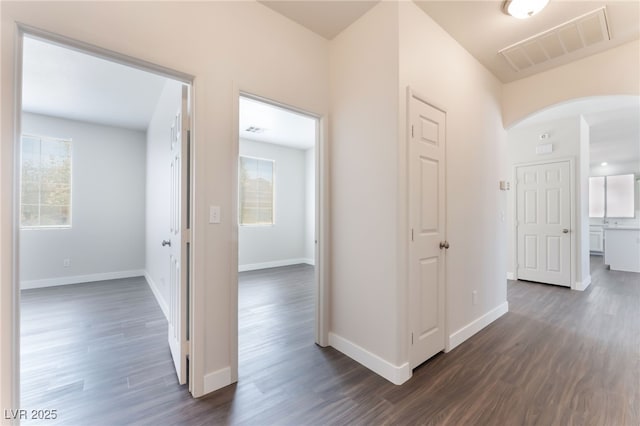 6140 Passionate Ct, North Las Vegas, NV 89031 - corridor with arched walkways, dark wood-style flooring, and baseboards
