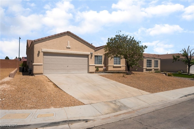 6140 Passionate Ct, North Las Vegas, NV 89031 - ranch-style home featuring an attached garage, concrete driveway, stucco siding, and a tiled roof