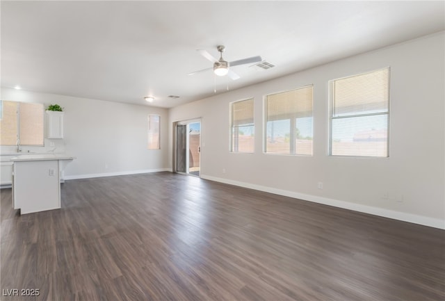 6140 Passionate Ct, North Las Vegas, NV 89031 - unfurnished living room with ceiling fan, dark wood finished floors, and baseboards