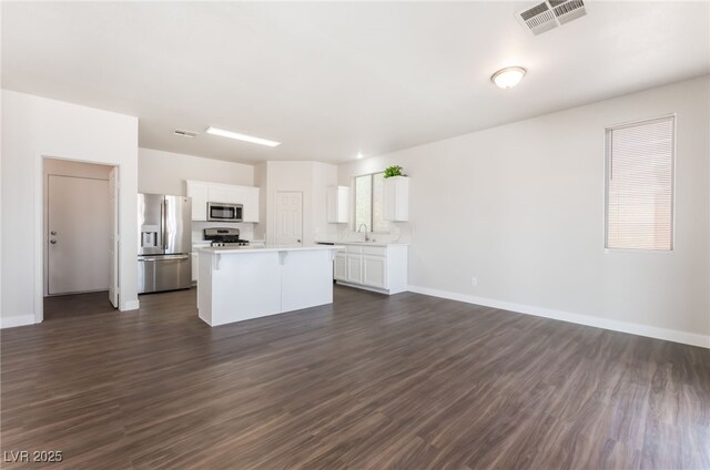 6140 Passionate Ct, North Las Vegas, NV 89031 - kitchen featuring appliances with stainless steel finishes, a sink, a kitchen island, light countertops, and white cabinetry