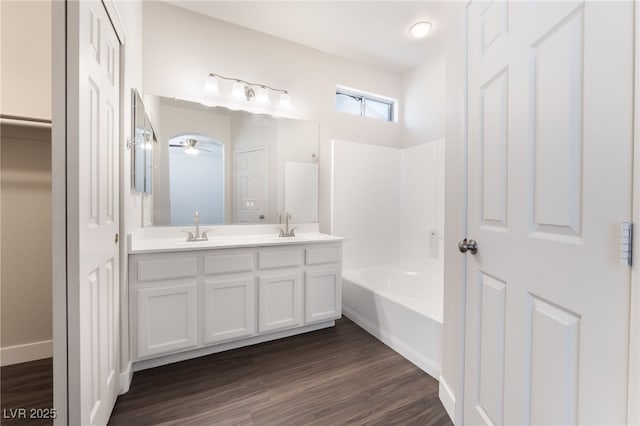 6140 Passionate Ct, North Las Vegas, NV 89031 - bathroom featuring double vanity, a ceiling fan, wood finished floors, and shower / tub combination