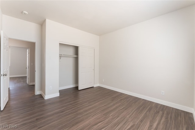 6140 Passionate Ct, North Las Vegas, NV 89031 - unfurnished bedroom with dark wood-style flooring, baseboards, and a closet