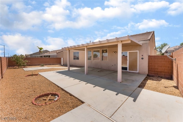 6140 Passionate Ct, North Las Vegas, NV 89031 - rear view of property featuring stucco siding, a fenced backyard, a patio area, and a tiled roof