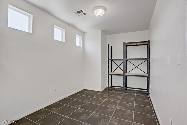 5135 Paradise Valley Ave, Las Vegas, NV 89156 - empty room featuring dark tile patterned flooring and baseboards
