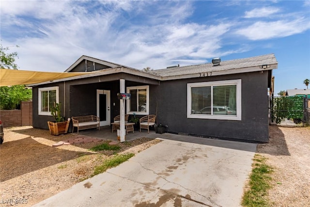 3417 Lillis Cir, North Las Vegas, NV 89030 - view of front facade featuring a patio area, stucco siding, and an outdoor hangout area