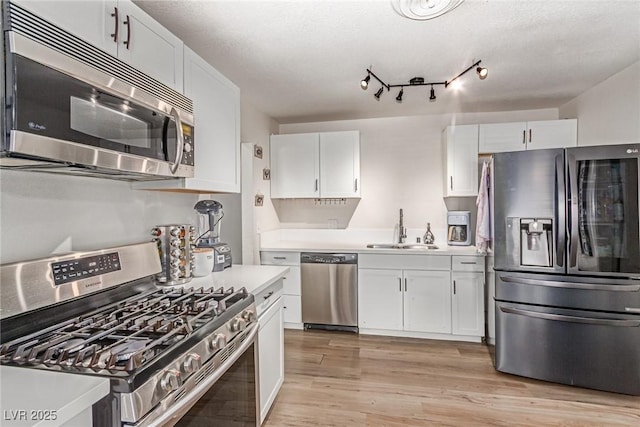 3417 Lillis Cir, North Las Vegas, NV 89030 - kitchen with stainless steel appliances, a sink, light countertops, and white cabinetry