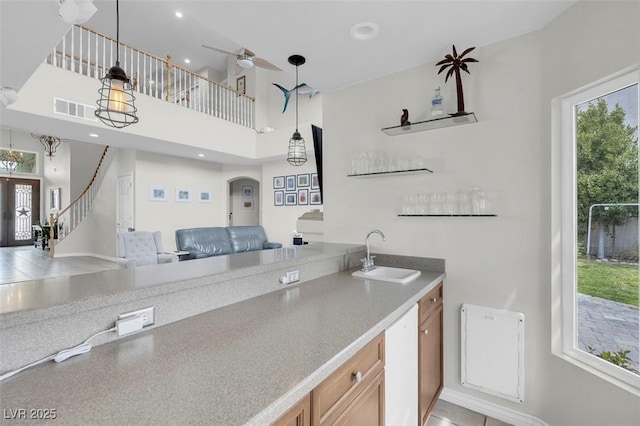 4326 Spooner Lake Cir, Las Vegas, NV 89147 - kitchen featuring a sink, open floor plan, hanging light fixtures, a ceiling fan, and baseboards