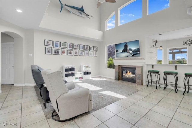 4326 Spooner Lake Cir, Las Vegas, NV 89147 - tiled living area with arched walkways, ceiling fan, a fireplace, baseboards, and recessed lighting