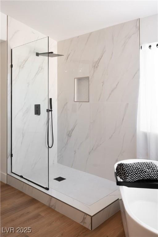 7825 Desert Bell Ave, Las Vegas, NV 89128 - bathroom featuring a marble finish shower and wood finished floors