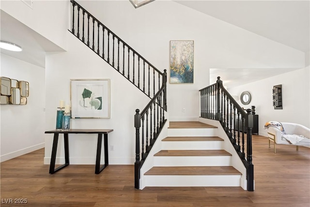 7825 Desert Bell Ave, Las Vegas, NV 89128 - staircase with wood finished floors, high vaulted ceiling, and baseboards