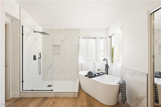 7825 Desert Bell Ave, Las Vegas, NV 89128 - full bath with a marble finish shower, a soaking tub, and wood finished floors