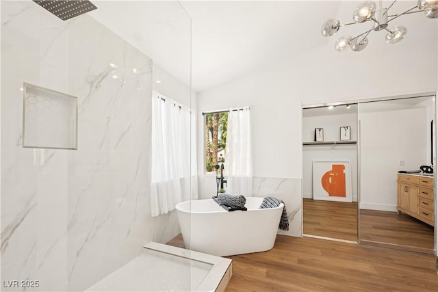 7825 Desert Bell Ave, Las Vegas, NV 89128 - bathroom with a marble finish shower, a freestanding bath, wood finished floors, and a chandelier