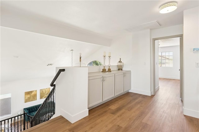 7825 Desert Bell Ave, Las Vegas, NV 89128 - bar with light wood-type flooring, baseboards, and vaulted ceiling