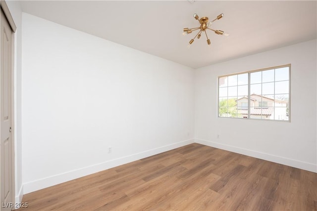 7825 Desert Bell Ave, Las Vegas, NV 89128 - unfurnished room featuring baseboards and light wood-style flooring