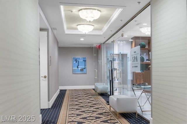2000 N Fashion Show Dr Unit 5326, Las Vegas, NV 89109 - hall featuring a raised ceiling, a chandelier, baseboards, and crown molding