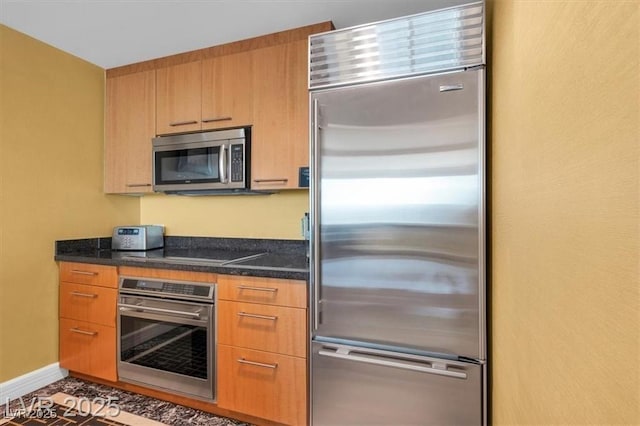 2000 N Fashion Show Dr Unit 5326, Las Vegas, NV 89109 - kitchen featuring stainless steel appliances, dark stone countertops, and baseboards