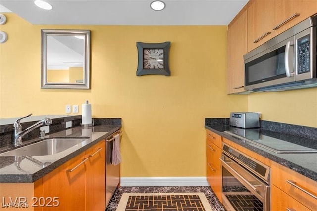 2000 N Fashion Show Dr Unit 5326, Las Vegas, NV 89109 - kitchen with stainless steel appliances, a sink, baseboards, dark stone countertops, and recessed lighting