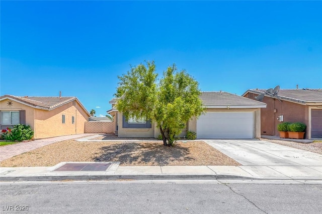2103 Falcon Crest Ave, North Las Vegas, NV 89031 - view of front facade with an attached garage, stucco siding, and driveway
