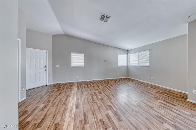 2103 Falcon Crest Ave, North Las Vegas, NV 89031 - empty room with lofted ceiling, light wood finished floors, and baseboards
