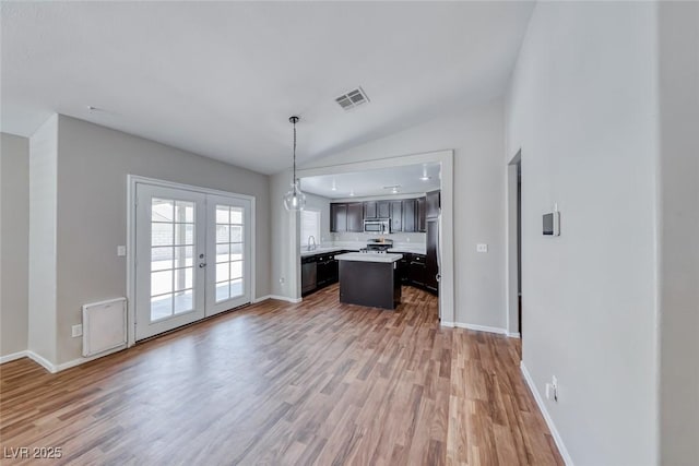 2103 Falcon Crest Ave, North Las Vegas, NV 89031 - kitchen featuring stainless steel microwave, open floor plan, light countertops, light wood-style floors, and baseboards