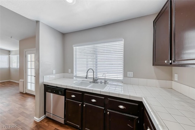 2103 Falcon Crest Ave, North Las Vegas, NV 89031 - kitchen featuring dishwasher, a sink, dark brown cabinets, tile countertops, and wood finished floors