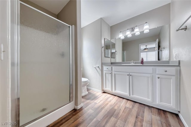 2103 Falcon Crest Ave, North Las Vegas, NV 89031 - full bath featuring toilet, a shower stall, vanity, and wood finished floors