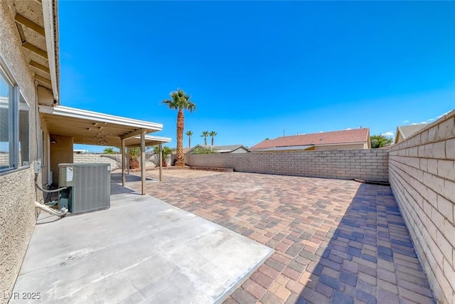 2103 Falcon Crest Ave, North Las Vegas, NV 89031 - fenced backyard featuring central air condition unit and a patio area