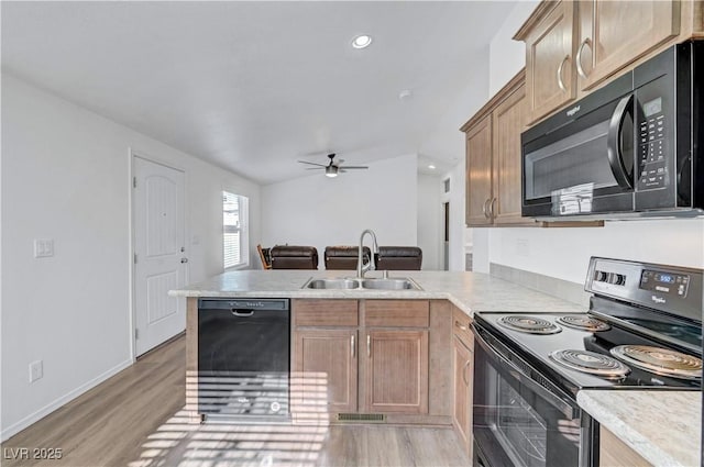 5725 N Durango Dr, Las Vegas, NV 89149 - kitchen with black appliances, a sink, a peninsula, light countertops, and recessed lighting