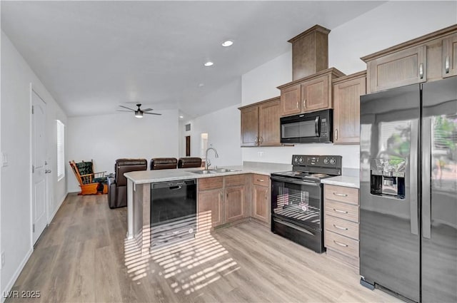 5725 N Durango Dr, Las Vegas, NV 89149 - kitchen with black appliances, a sink, a ceiling fan, light wood-style flooring, and light countertops