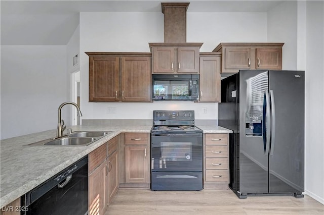 5725 N Durango Dr, Las Vegas, NV 89149 - kitchen featuring black appliances, a sink, light wood-style floors, and light countertops