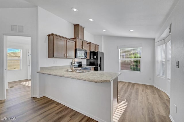 5725 N Durango Dr, Las Vegas, NV 89149 - kitchen featuring stainless steel appliances, light wood-type flooring, a peninsula, baseboards, and recessed lighting