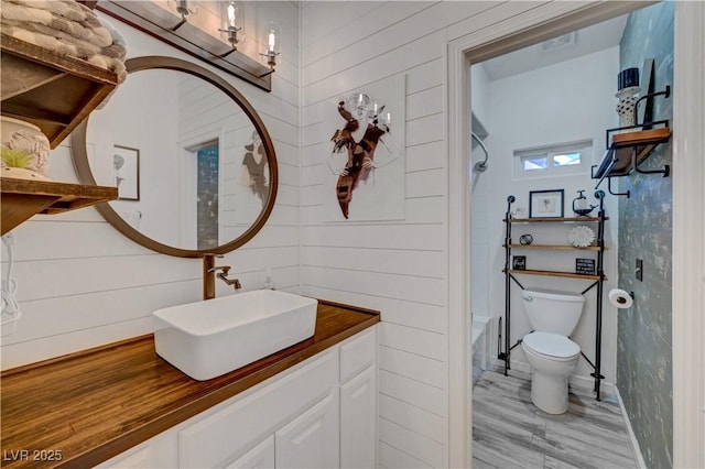 5725 N Durango Dr, Las Vegas, NV 89149 - full bathroom with toilet, vanity, wood finished floors, and washtub / shower combination