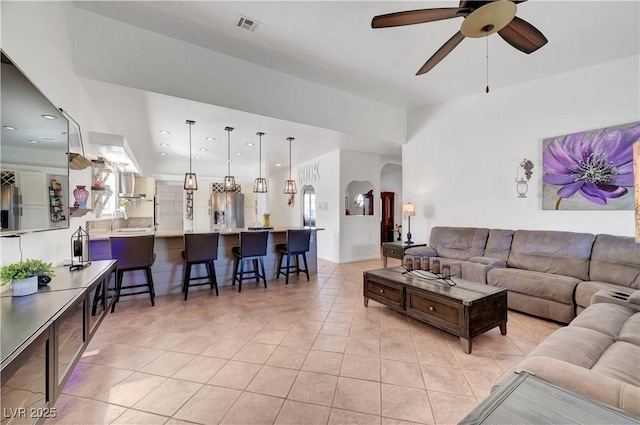 5725 N Durango Dr, Las Vegas, NV 89149 - living room with ceiling fan, light tile patterned floors, arched walkways, and recessed lighting