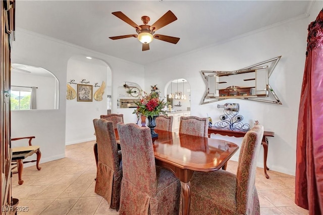 5725 N Durango Dr, Las Vegas, NV 89149 - dining room with ceiling fan, arched walkways, light tile patterned floors, ornamental molding, and baseboards