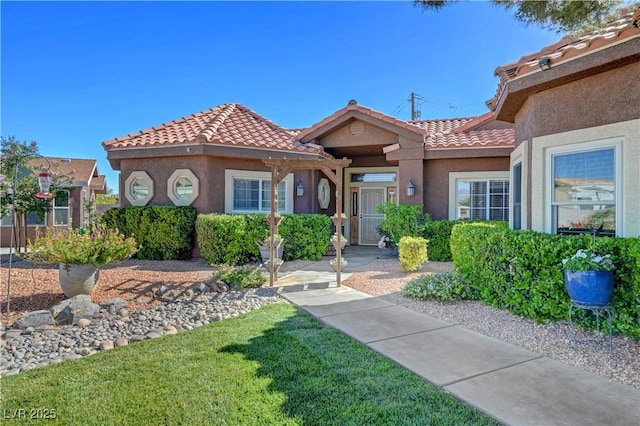 5725 N Durango Dr, Las Vegas, NV 89149 - view of front of property with a tile roof, stucco siding, and a front yard