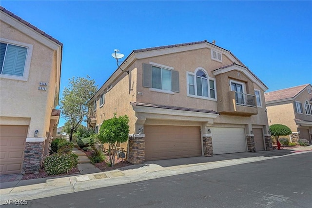 1574 Ward Frontier Ln, Henderson, NV 89002 - townhome / multi-family property with stone siding, stucco siding, and a garage