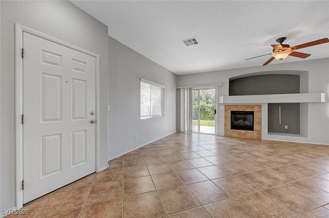 1574 Ward Frontier Ln, Henderson, NV 89002 - unfurnished living room featuring tile patterned flooring, ceiling fan, a fireplace, and baseboards